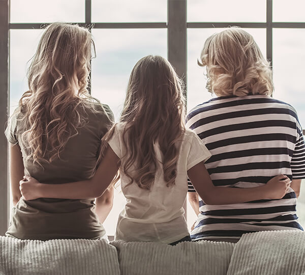 Female family members looking out window