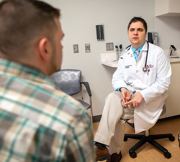 physician speaking to male patient