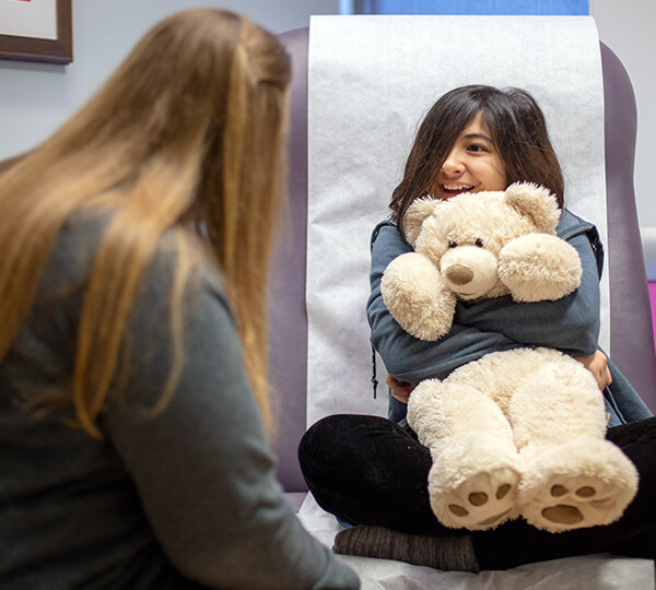 Female patient with teddy bear smiling
