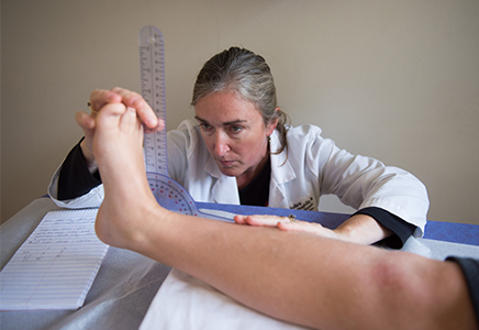 Physical therapist examining ankle