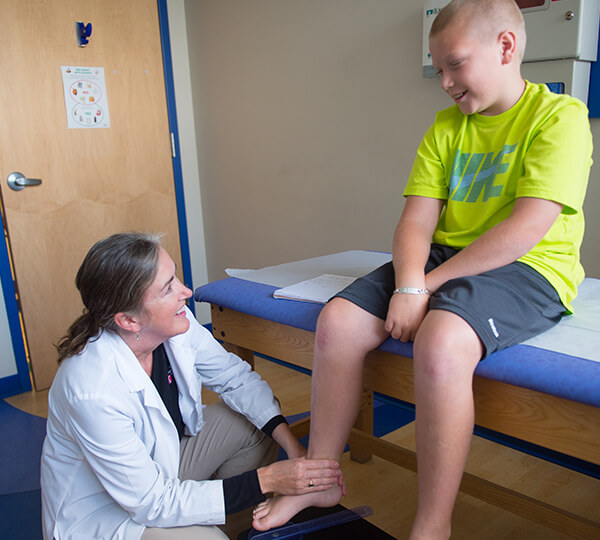 PT examining boy's ankle