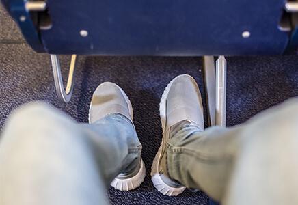 View of legs and feet from airline seat