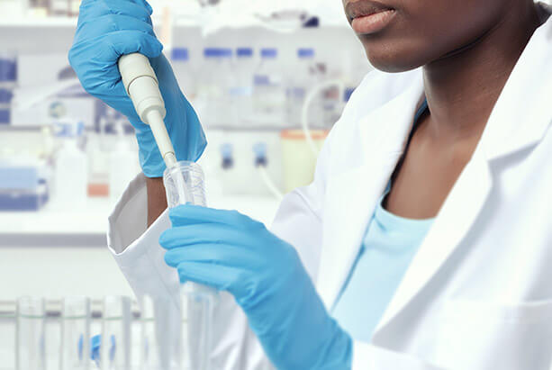 Scientist hands dropping in vial in lab